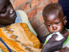 15 November 2016. Aweil: Abuk Ngor feeds her child with severe malnutrition, Achan Akot (2), with Plumpy'Nut (a peanut-based paste) at the feeding centre (outpatient therapeutic programming) run by Medair in Aweil, South Sudan
Alarming levels of malnutrition and an upsurge in malaria numbers put thousands of lives at risks in Northern Bahr el Ghazal, South Sudan. A full-scale emergency response has been launched by the humanitarian community. Medair, an international emergency relief and recovery organisation, is part of this response and is providing emergency nutrition and health services, safe water, and sanitation and hygiene support
	The emergency levels of malnutrition are compounded by a malaria upsurge in the past weeks and the limited access to water and sanitation facilities. The limited availability of essential drugs and the small number of staff in health facilities have made it very difficult for people to receive adequate treatment in time unless they have enough money to pay. .Medairs emergency response team is providing critical services to the most vulnerable in the area. The team has set up three emergency nutrition clinics to treat children under five with acute malnutrition.
Photo by Albert Gonzalez Farran - MEDAIR